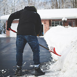 man snow shovel image local lawn care company website london ontario